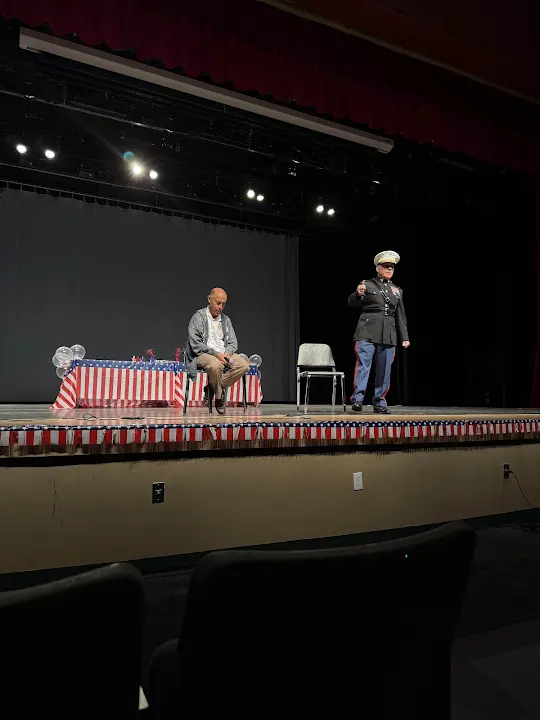 A United States Marine speaking on stage at a Valor and Unity Crew event
